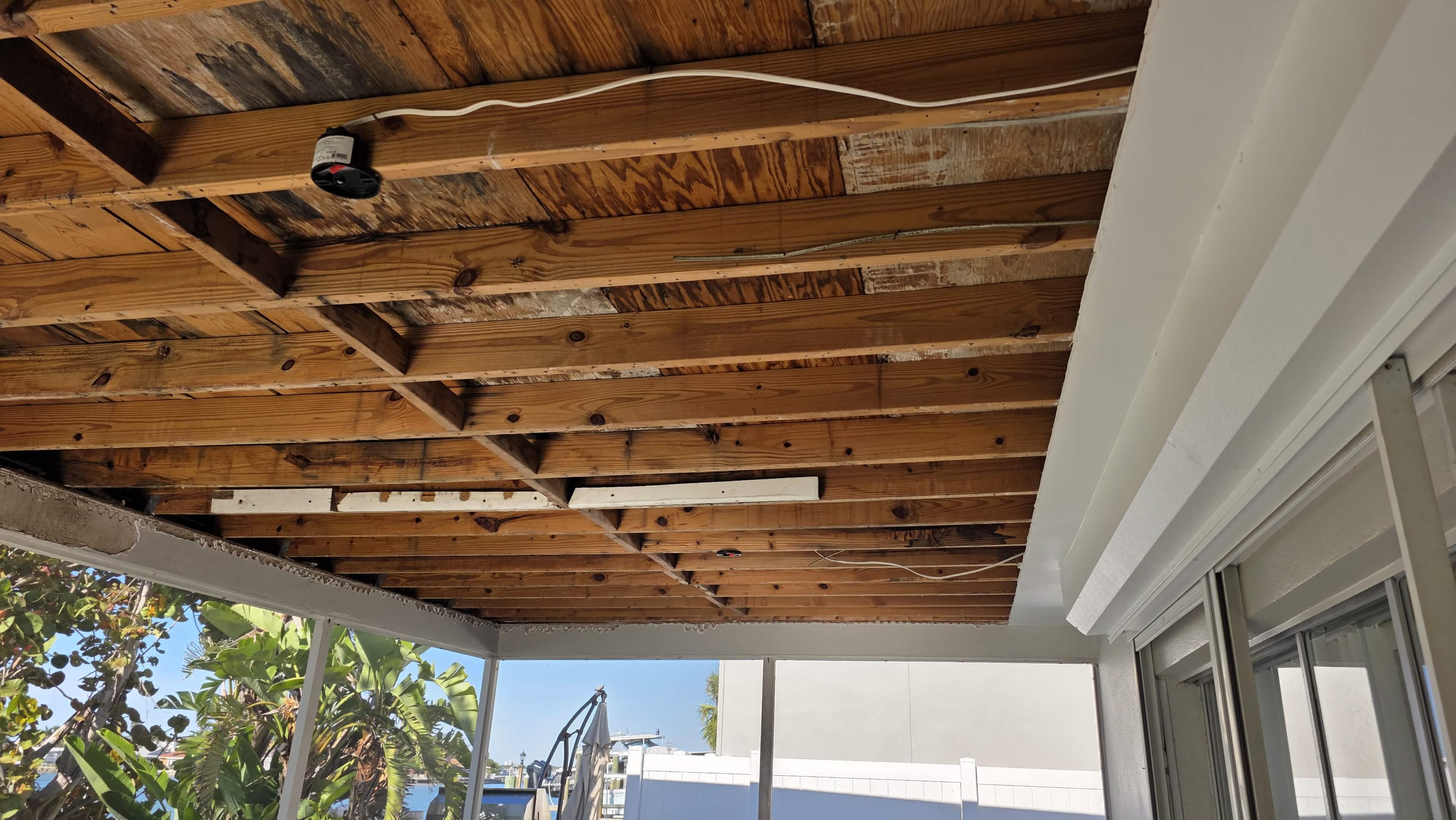 Old drywall removed, exposed ceiling framing